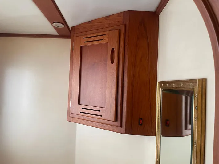 Endurance Yacht Photos Pics Wooden cabinet and mirror inside 2006 Duffy Pilothouse Fast Trawler boat interior.
