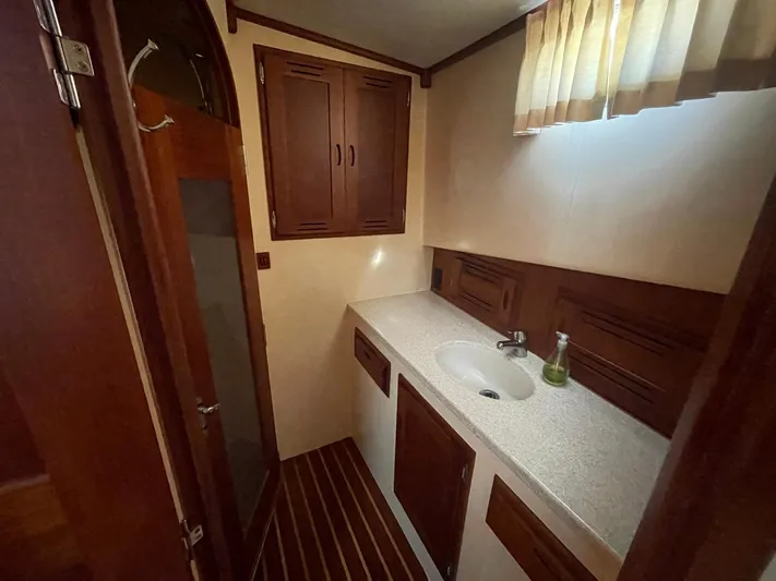 Endurance Yacht Photos Pics 2006 Duffy Pilothouse Fast Trawler bathroom with wooden cabinets and countertop sink.