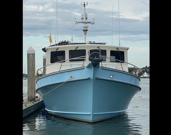Endurance Yacht Photos Pics 2006 Duffy Pilothouse Fast Trawler docked, front view, blue hull, calm water.