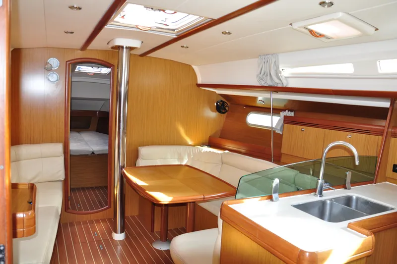 Nomad Yacht Photos Pics Interior of 2008 Jeanneau Sun Odyssey 39i yacht with modern kitchen and seating area.
