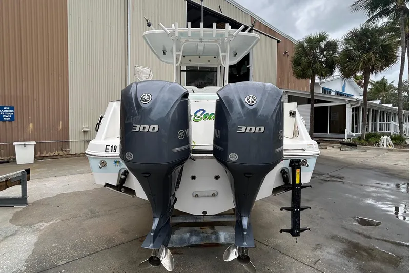 302-176 Brokerage Anthony Yacht Photos Pics 2018 Robalo R302 Center Console boat with dual Yamaha 300 engines, docked outdoors.