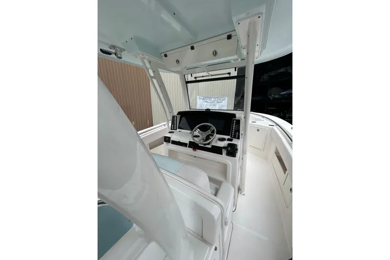 302-176 Brokerage Anthony Yacht Photos Pics 2018 Robalo R302 Center Console boat interior with steering wheel and navigation equipment.