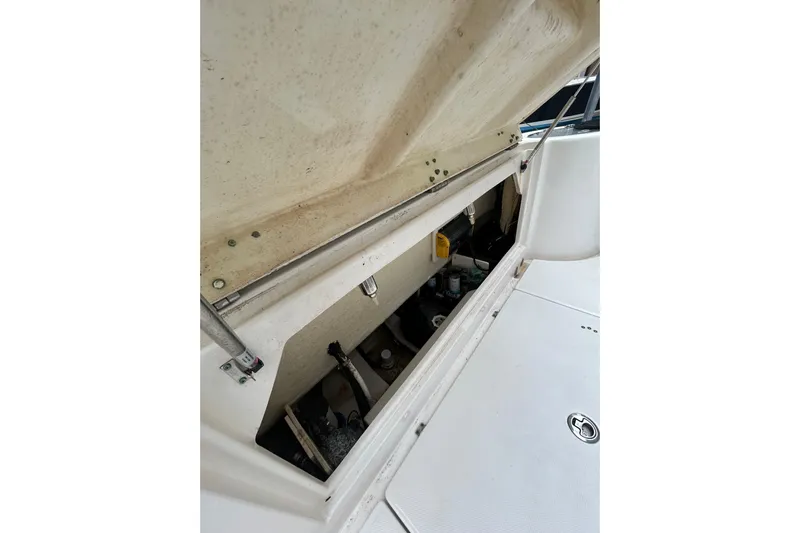 302-176 Brokerage Anthony Yacht Photos Pics 2018 Robalo R302 Center Console storage compartment with open hatch, showcasing interior details.