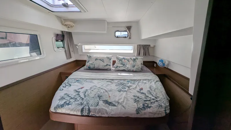 Solace Yacht Photos Pics 2020 Lagoon 42 yacht cabin with floral bedding and natural light.