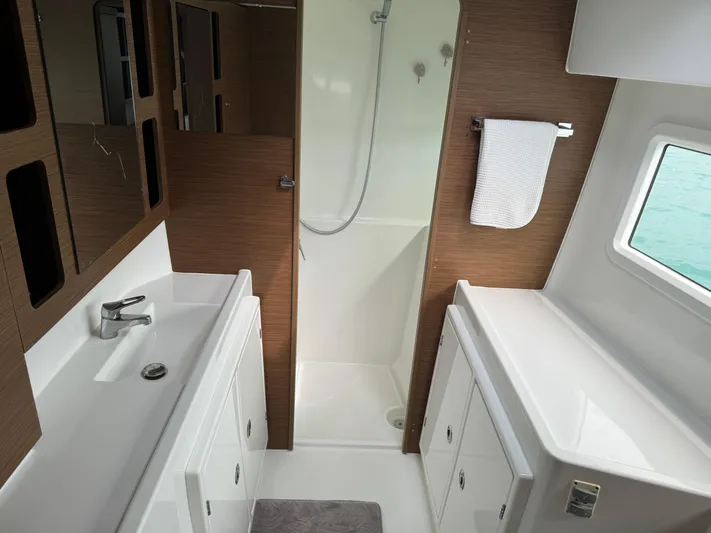 Solace Yacht Photos Pics Modern bathroom interior of 2020 Lagoon 42 yacht with shower and sink.