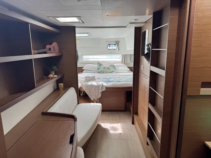 Solace Yacht Photos Pics Luxurious interior of a 2020 Lagoon 42 catamaran, featuring a cozy bedroom and modern furnishings.