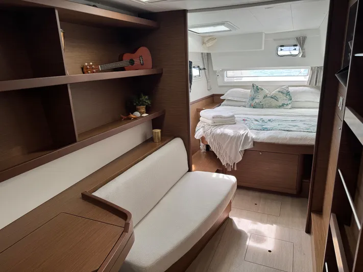 Solace Yacht Photos Pics Interior of 2020 Lagoon 42 yacht with cozy bedroom and seating area.