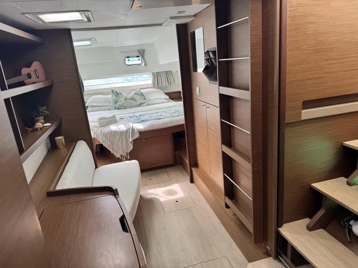 Solace Yacht Photos Pics Interior of 2020 Lagoon 42 catamaran with cozy bedroom and modern wooden furnishings.