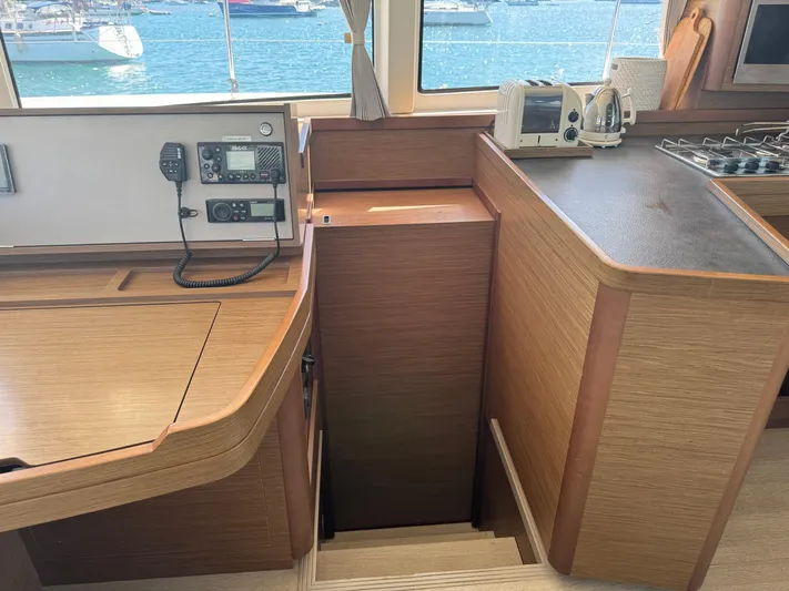 Solace Yacht Photos Pics Interior of 2020 Lagoon 42 yacht with navigation equipment and kitchen area.