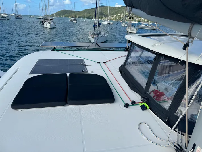 Solace Yacht Photos Pics 2020 Lagoon 42 catamaran on calm waters, featuring spacious deck and sleek design.