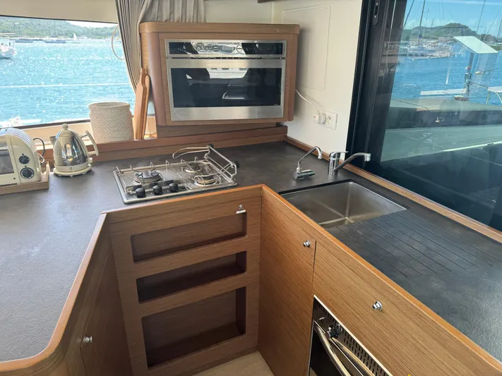 Solace Yacht Photos Pics Modern kitchen in 2020 Lagoon 42 yacht with ocean view, featuring stove and sink.