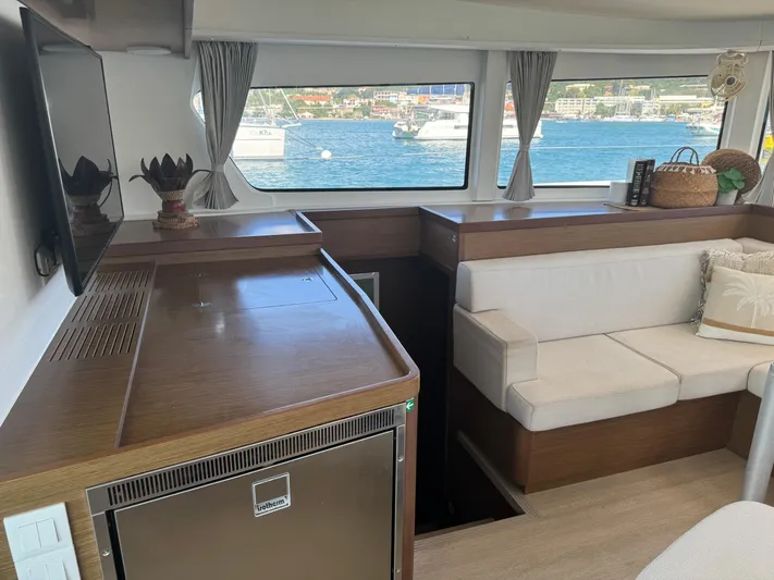 Solace Yacht Photos Pics Interior of 2020 Lagoon 42 catamaran with modern seating and scenic window views.