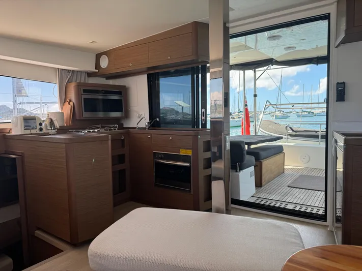 Solace Yacht Photos Pics Interior of 2020 Lagoon 42 yacht with modern kitchen and marina view.