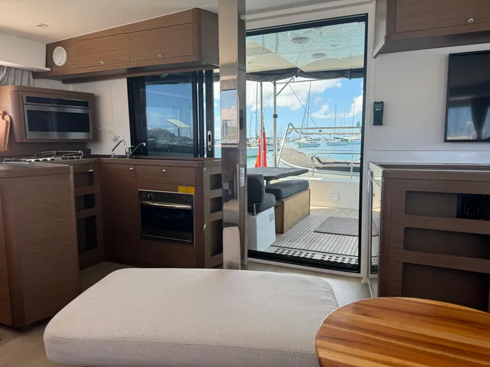 Solace Yacht Photos Pics Interior of 2020 Lagoon 42 yacht with modern kitchen and marina view.