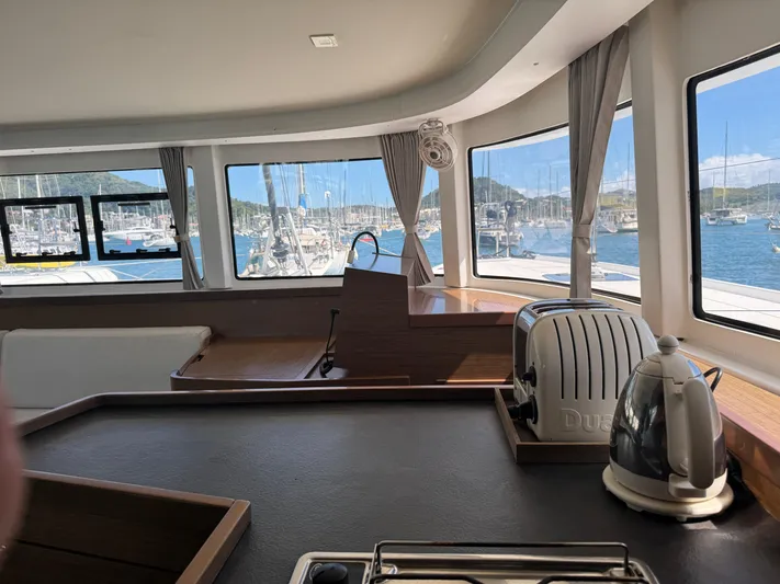 Solace Yacht Photos Pics Interior of 2020 Lagoon 42 yacht with kitchen appliances and marina view.