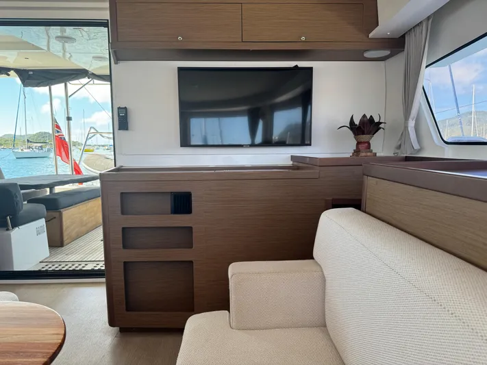 Solace Yacht Photos Pics Interior of 2020 Lagoon 42 yacht with modern decor, TV, and comfortable seating.