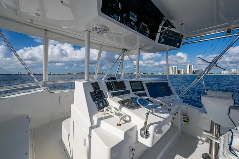 Navigator Yacht Photos Pics 1998 Viking 50 Convertible yacht helm with ocean view and city skyline in background.