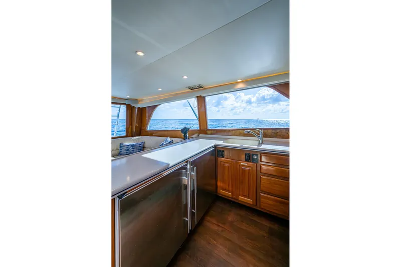 Navigator Yacht Photos Pics Luxurious interior of 1998 Viking 50 Convertible yacht with ocean view through large windows.