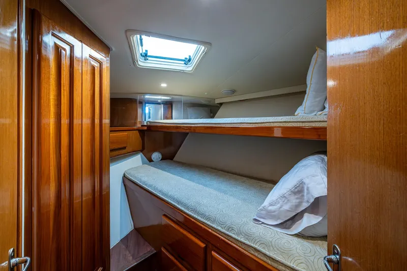 Navigator Yacht Photos Pics 1998 Viking 50 Convertible yacht cabin with wooden interior and bunk beds.