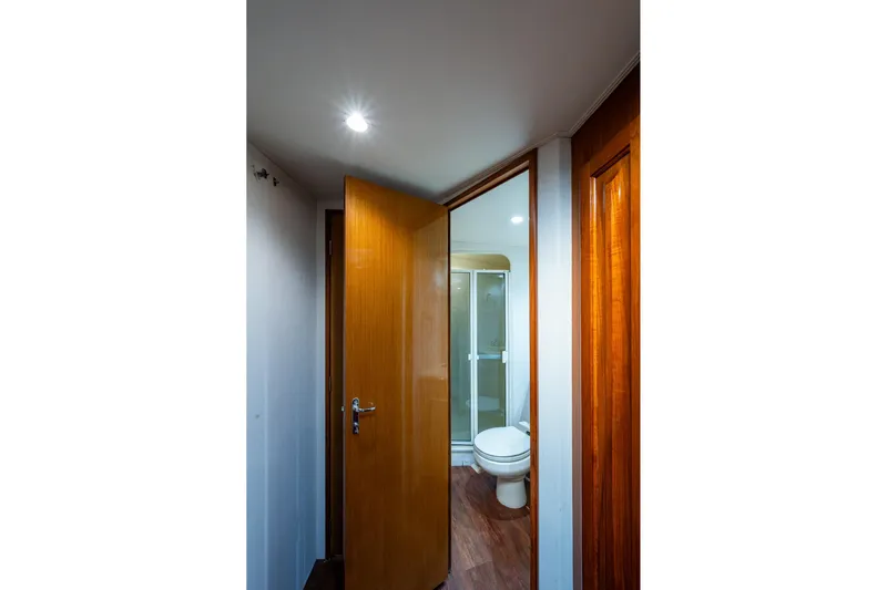 Navigator Yacht Photos Pics Bathroom interior of 1998 Viking 50 Convertible yacht with wooden door and modern fixtures.