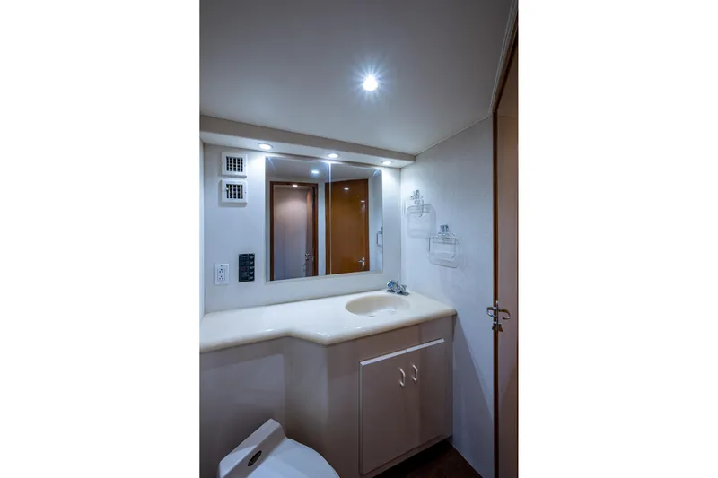 Navigator Yacht Photos Pics Bathroom interior of 1998 Viking 50 Convertible yacht, featuring sink and mirror.