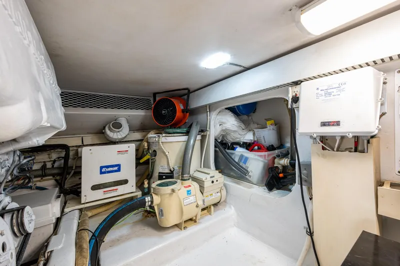 Navigator Yacht Photos Pics Engine room of 1998 Viking 50 Convertible yacht, featuring various mechanical components and storage.
