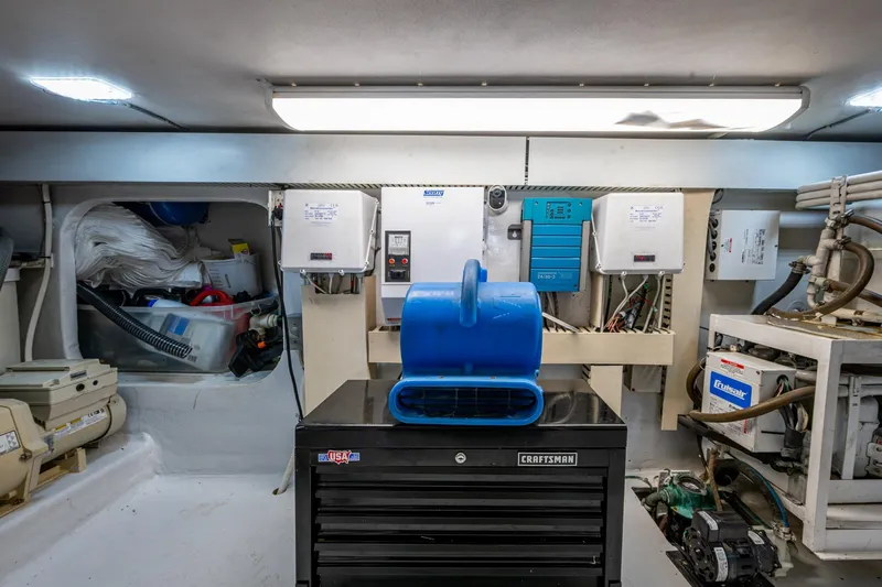 Navigator Yacht Photos Pics Engine room of 1998 Viking 50 Convertible yacht with equipment and storage.