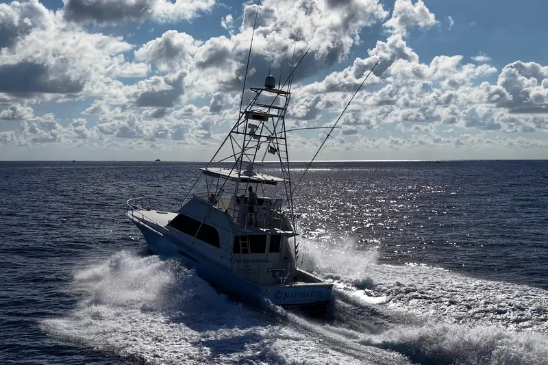Navigator Yacht Photos Pics 1998 Viking 50 Convertible yacht navigating ocean waves under a cloudy sky.