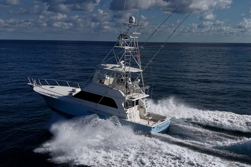 Navigator Yacht Photos Pics 1998 Viking 50 Convertible yacht cruising on open ocean under cloudy sky.