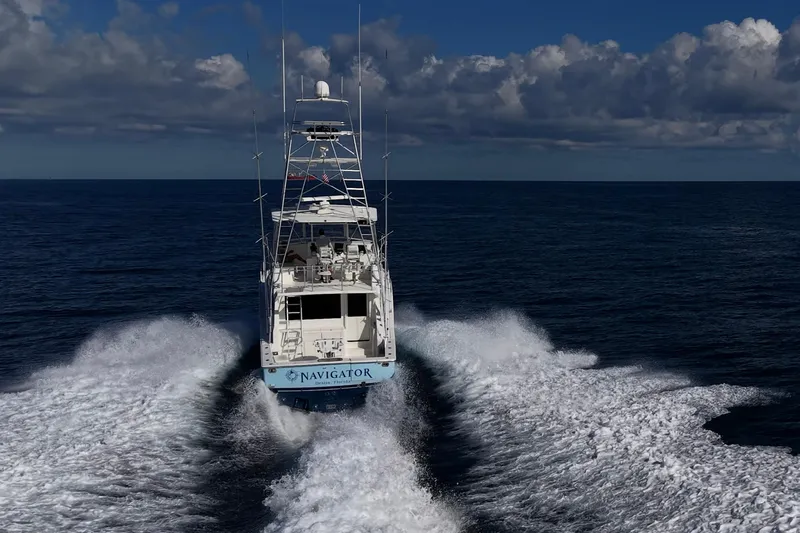 Navigator Yacht Photos Pics 1998 Viking 50 Convertible yacht cruising on open ocean under cloudy sky.