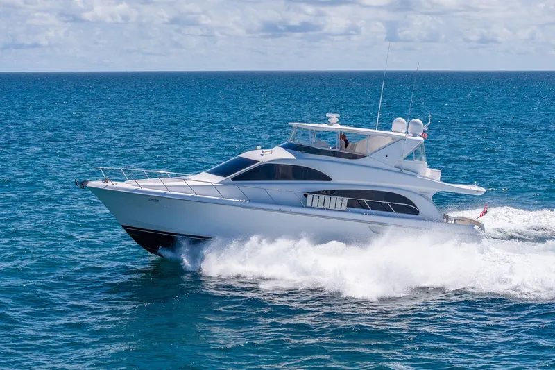 Starka Yacht Photos Pics 2009 Hatteras 64 Motor Yacht cruising on open ocean under clear skies.