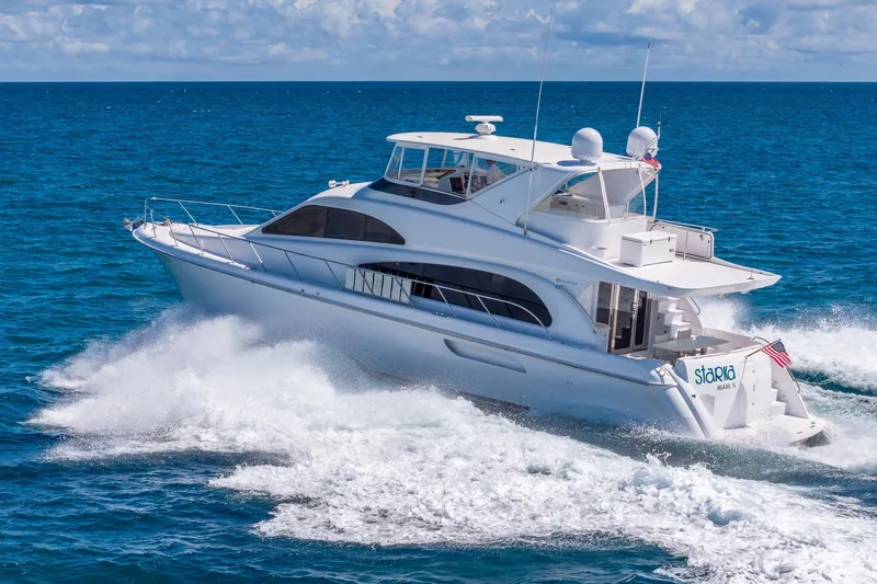 Starka Yacht Photos Pics 2009 Hatteras 64 Motor Yacht cruising on open ocean under clear skies.