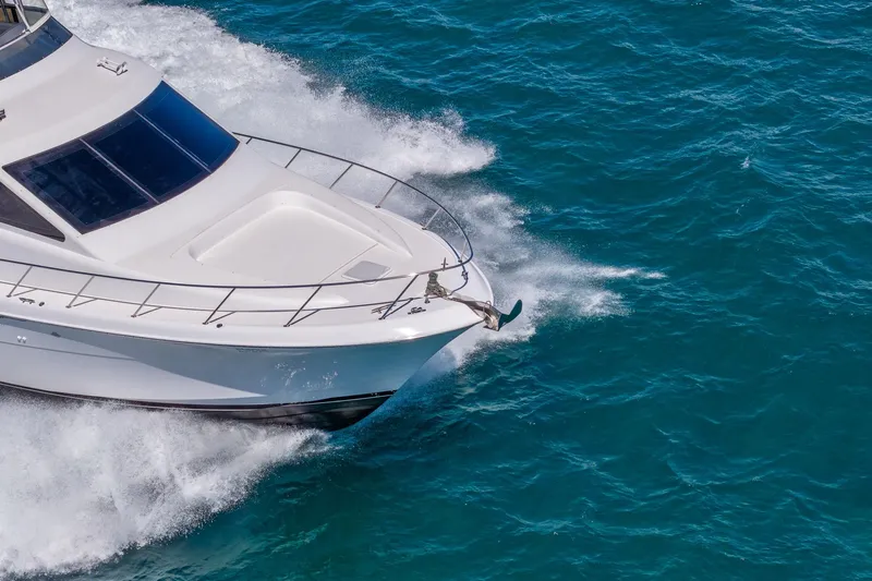 Starka Yacht Photos Pics 2009 Hatteras 64 Motor Yacht cruising on vibrant blue ocean waters.