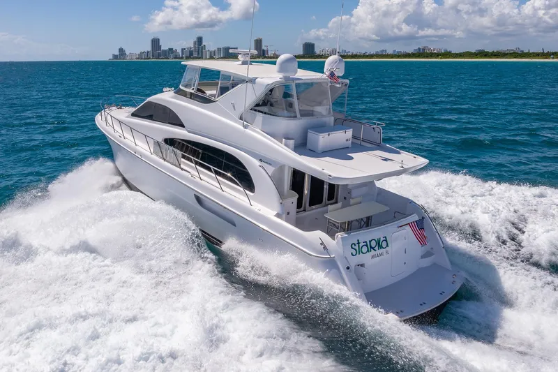 Starka Yacht Photos Pics 2009 Hatteras 64 Motor Yacht cruising near Miami skyline on a sunny day.