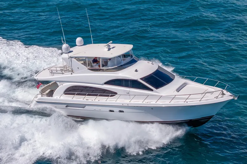 Starka Yacht Photos Pics 2009 Hatteras 64 Motor Yacht cruising on open water, showcasing sleek design and performance.