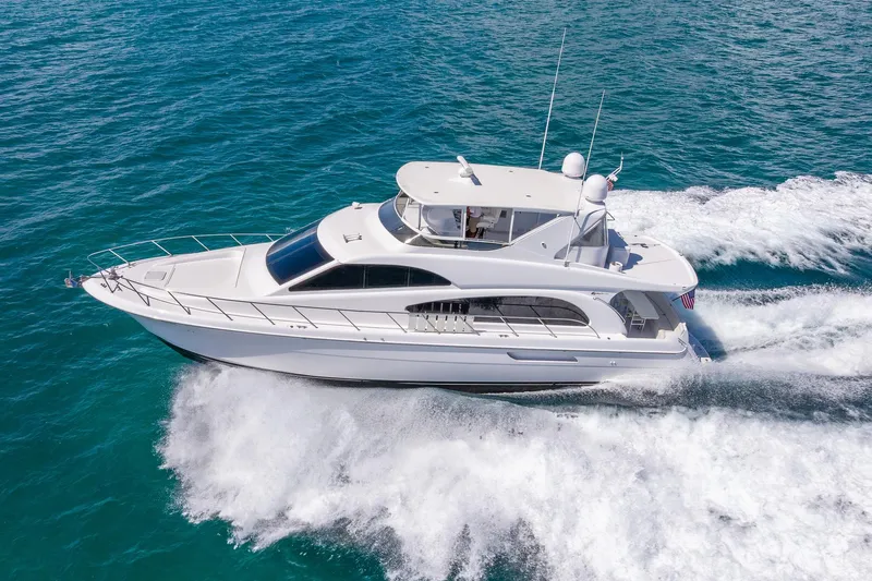 Starka Yacht Photos Pics 2009 Hatteras 64 Motor Yacht cruising on open water, side view.