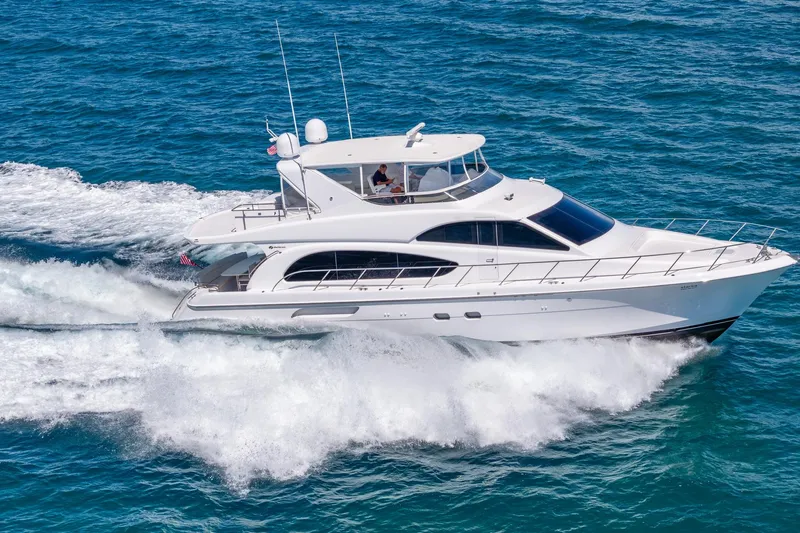 Starka Yacht Photos Pics 2009 Hatteras 64 Motor Yacht cruising on open water, showcasing sleek design and performance.