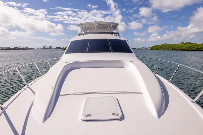 Starka Yacht Photos Pics 2009 Hatteras 64 Motor Yacht cruising on a sunny day with clear skies.