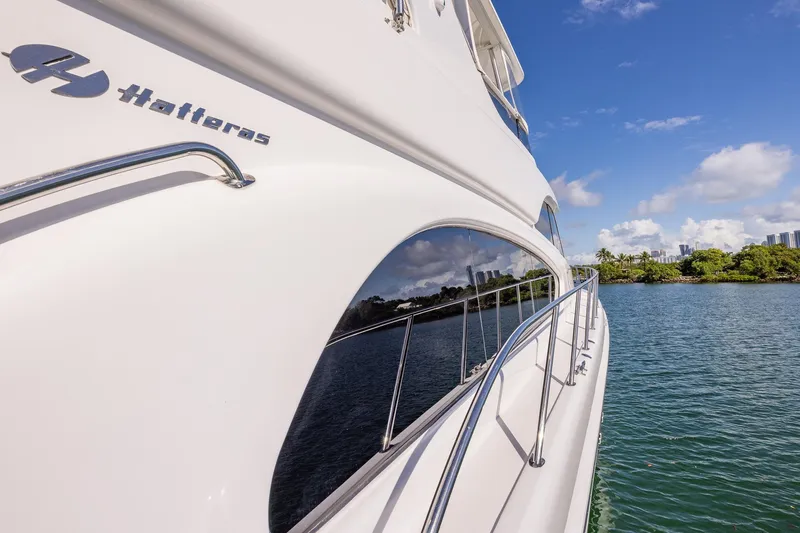 Starka Yacht Photos Pics 2009 Hatteras 64 Motor Yacht on serene water with clear blue sky.