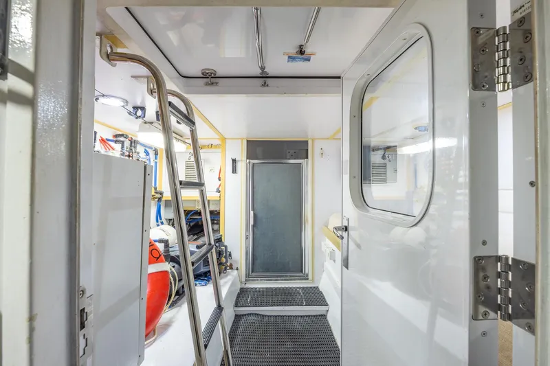 Starka Yacht Photos Pics Engine room of 2009 Hatteras 64 Motor Yacht with ladder and equipment.