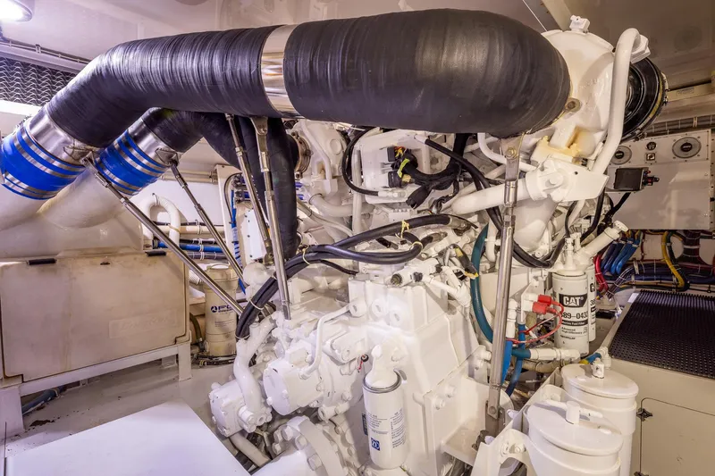 Starka Yacht Photos Pics Engine room of 2009 Hatteras 64 Motor Yacht, showcasing complex machinery and components.