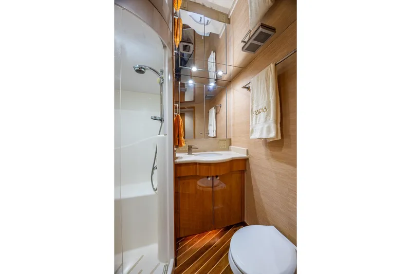 Starka Yacht Photos Pics Luxurious bathroom in 2009 Hatteras 64 Motor Yacht with shower and elegant wood finishes.