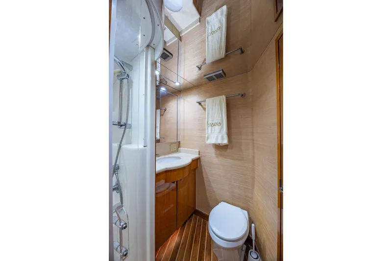 Starka Yacht Photos Pics Luxurious bathroom in 2009 Hatteras 64 Motor Yacht with modern fixtures and wooden accents.