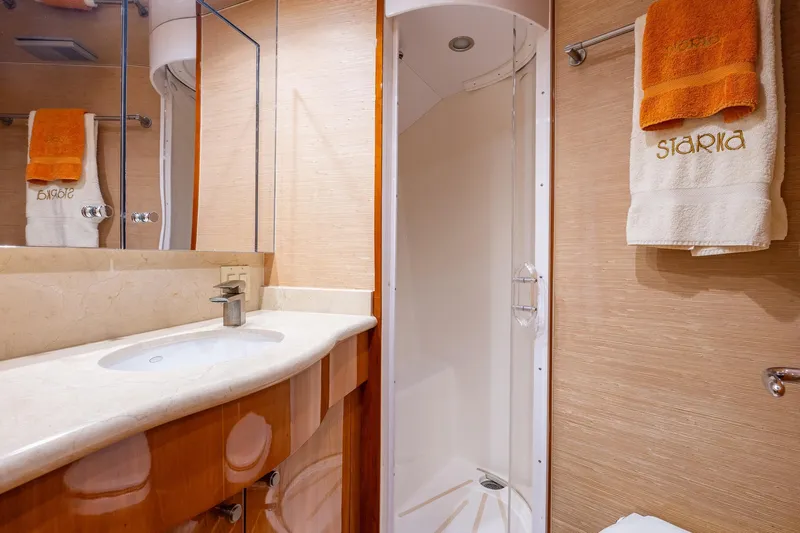 Starka Yacht Photos Pics Luxurious bathroom in 2009 Hatteras 64 Motor Yacht with shower and elegant vanity.