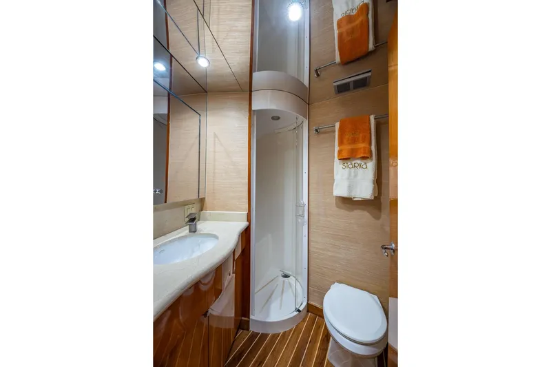 Starka Yacht Photos Pics Luxurious bathroom in 2009 Hatteras 64 Motor Yacht with shower, sink, and toilet.