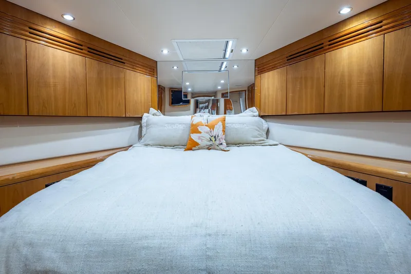 Starka Yacht Photos Pics Luxurious bedroom interior of 2009 Hatteras 64 Motor Yacht with wood cabinetry.