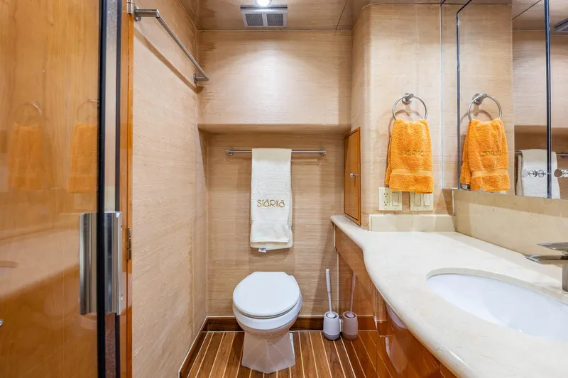 Starka Yacht Photos Pics Luxurious bathroom in 2009 Hatteras 64 Motor Yacht with elegant wood and marble finishes.