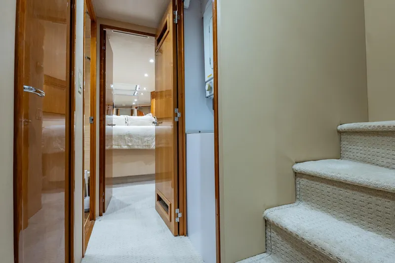 Starka Yacht Photos Pics Interior of 2009 Hatteras 64 Motor Yacht with carpeted stairs and wooden doors.