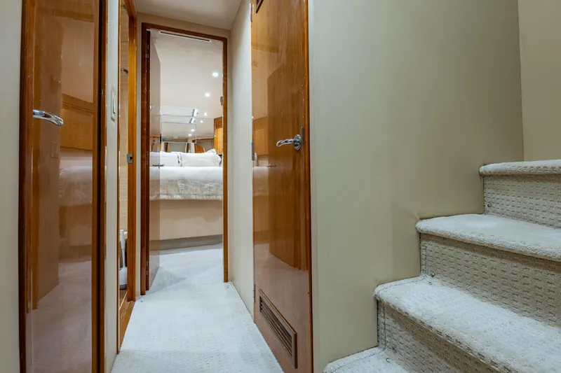 Starka Yacht Photos Pics Hallway and stairs inside 2009 Hatteras 64 Motor Yacht, leading to a cozy bedroom.