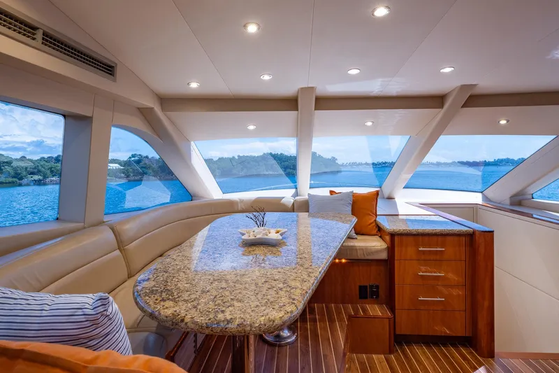Starka Yacht Photos Pics Luxurious interior of 2009 Hatteras 64 Motor Yacht with panoramic windows and elegant seating.